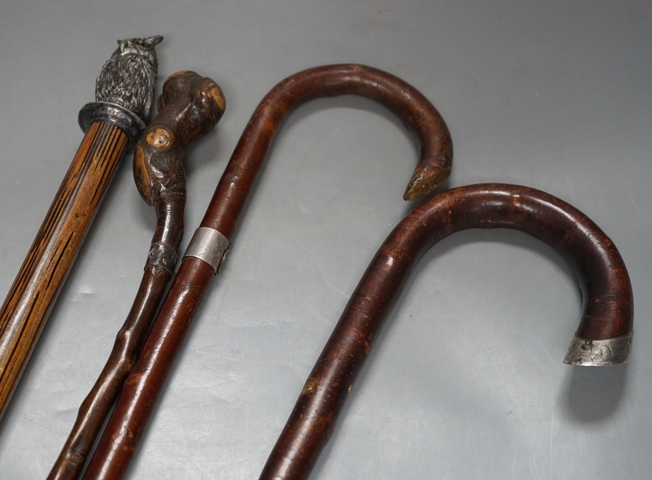 A silver mounted George V walking cane dated:London 1919 and 3 other canes, Silver mounted cane 92 cms long.